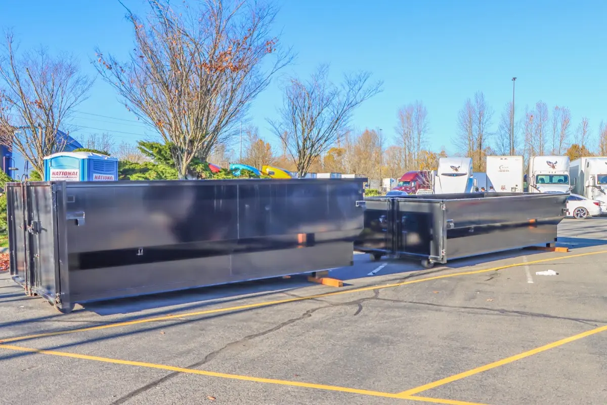 Professional dumpster rental service with roll-off container on residential driveway in Loomis